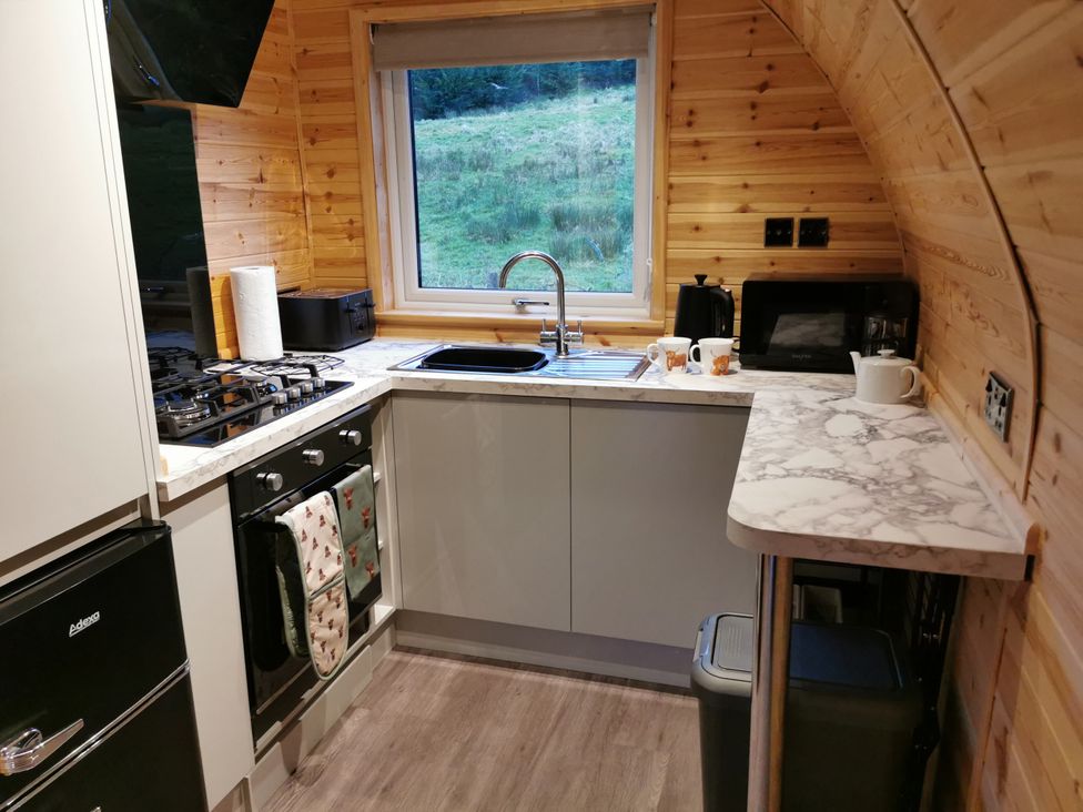 A kitchen with appliances and a window at Lodge 3 in Pontyates