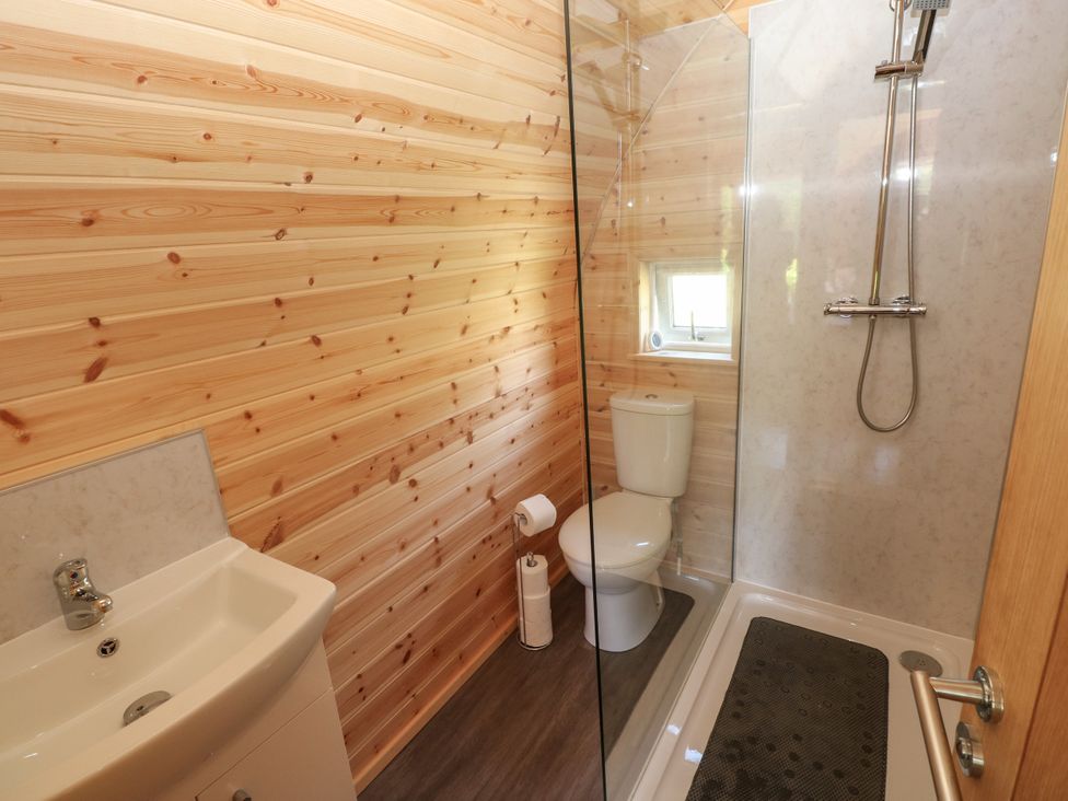A bathroom with a shower and sink at Lodge 3 near Pontyates
