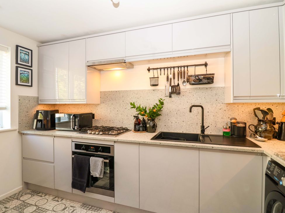 A kitchen with sink and appliances at 21 Olympic Way in Plymouth