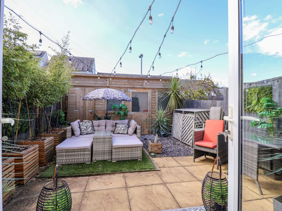 A garden with patio furniture and plants at 21 Olympic Way Plymouth