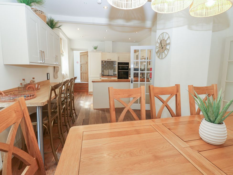 A dining room with a wooden table and chairs at Hampton House in St. Bees