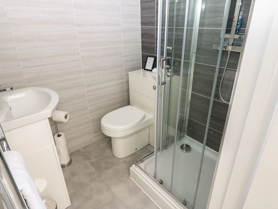 A bathroom with a shower, sink, and toilet at Hampton House St. Bees