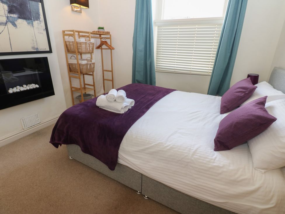A bedroom with a bed and towels at Hampton House St. Bees
