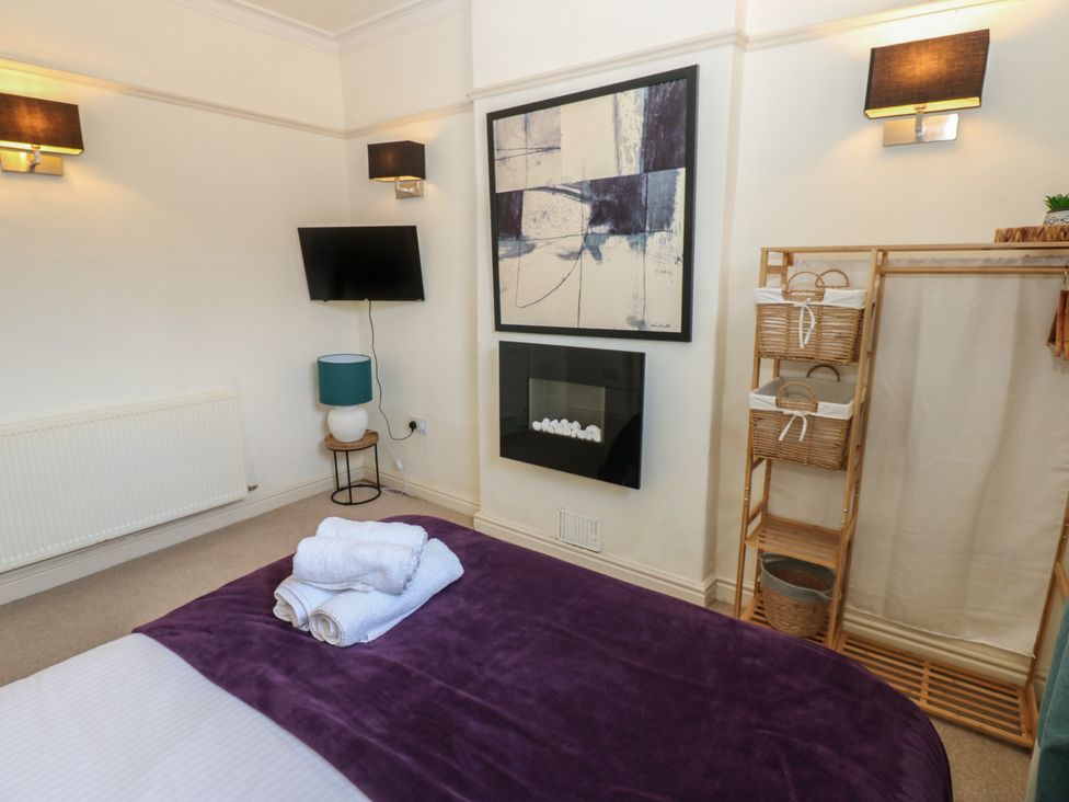 A bedroom with a bed and a television at Hampton House St. Bees