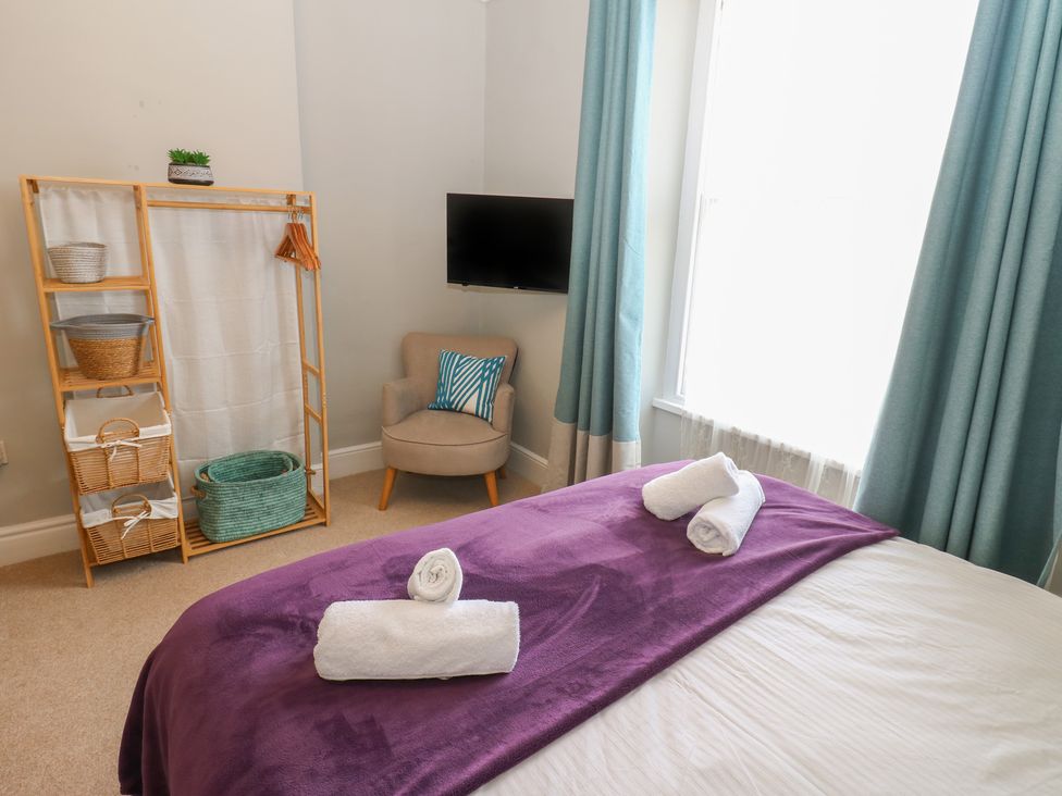 A bedroom with a bed and towels on it at Hampton House in St. Bees