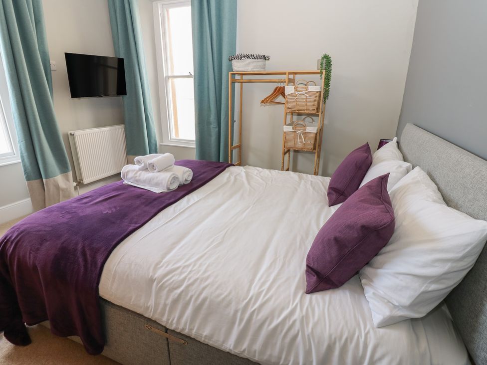 A bedroom with a bed and TV at Hampton House in St. Bees