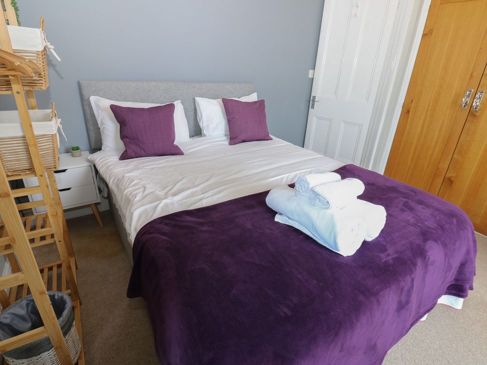 A bedroom with a bed and storage at Hampton House St. Bees