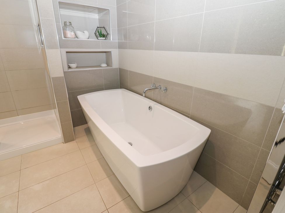 A bathroom with bathtub and shower at Hampton House St. Bees