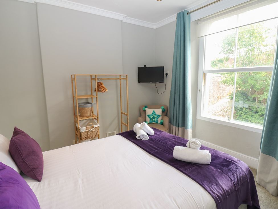 A bedroom with a bed and a TV at Hampton House in St. Bees
