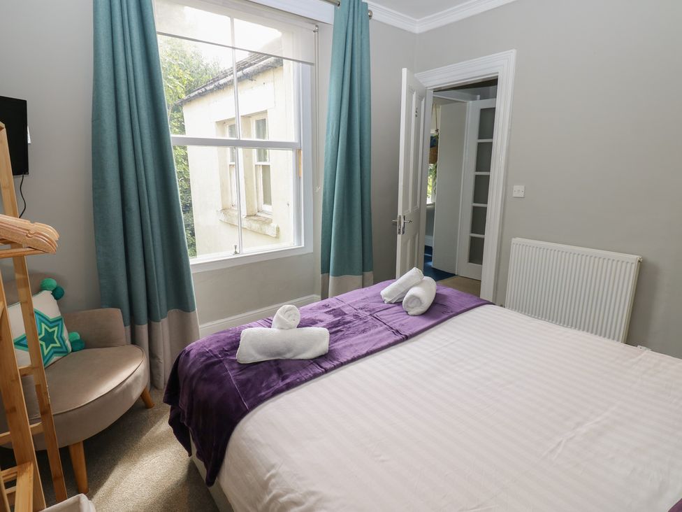 A bedroom with a bed and window at Hampton House St. Bees