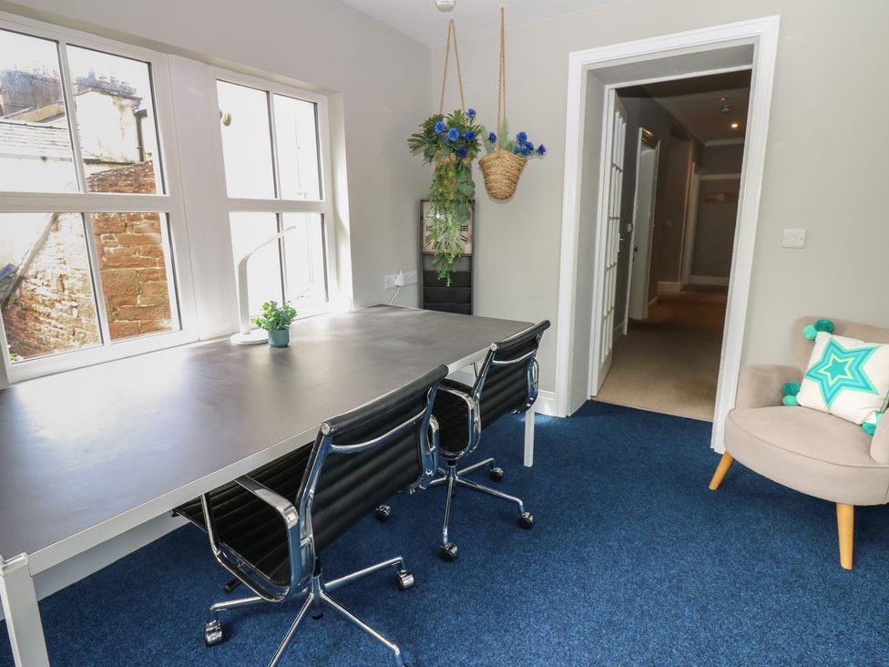 An office with a large desk and chairs at Hampton House in St. Bees