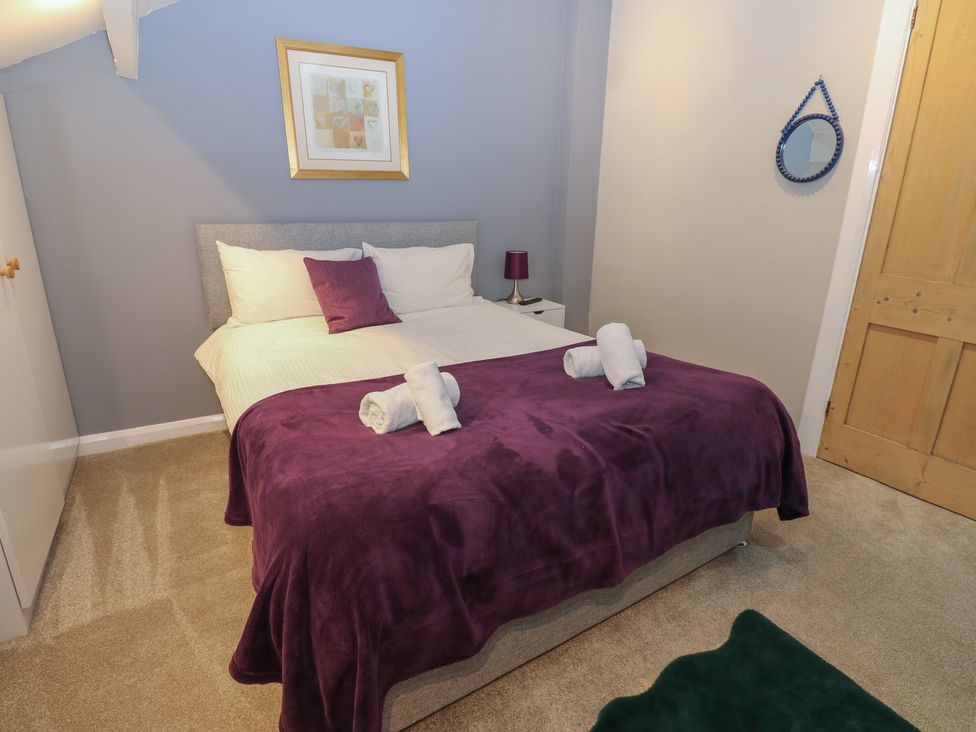 A bedroom with a bed and nightstand at Hampton House St. Bees