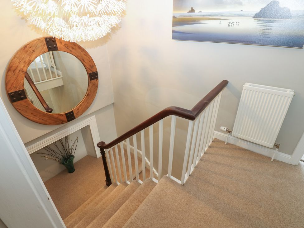 A hallway with a staircase and decor elements at Hampton House St. Bees
