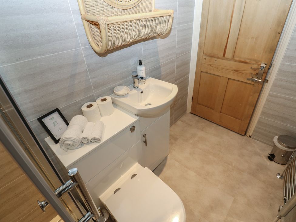 A bathroom with a toilet and sink at Hampton House in St. Bees