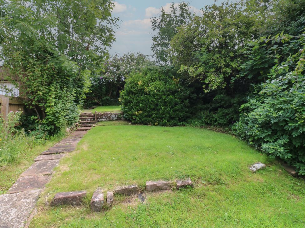 A garden with grass and trees at Hampton House St. Bees