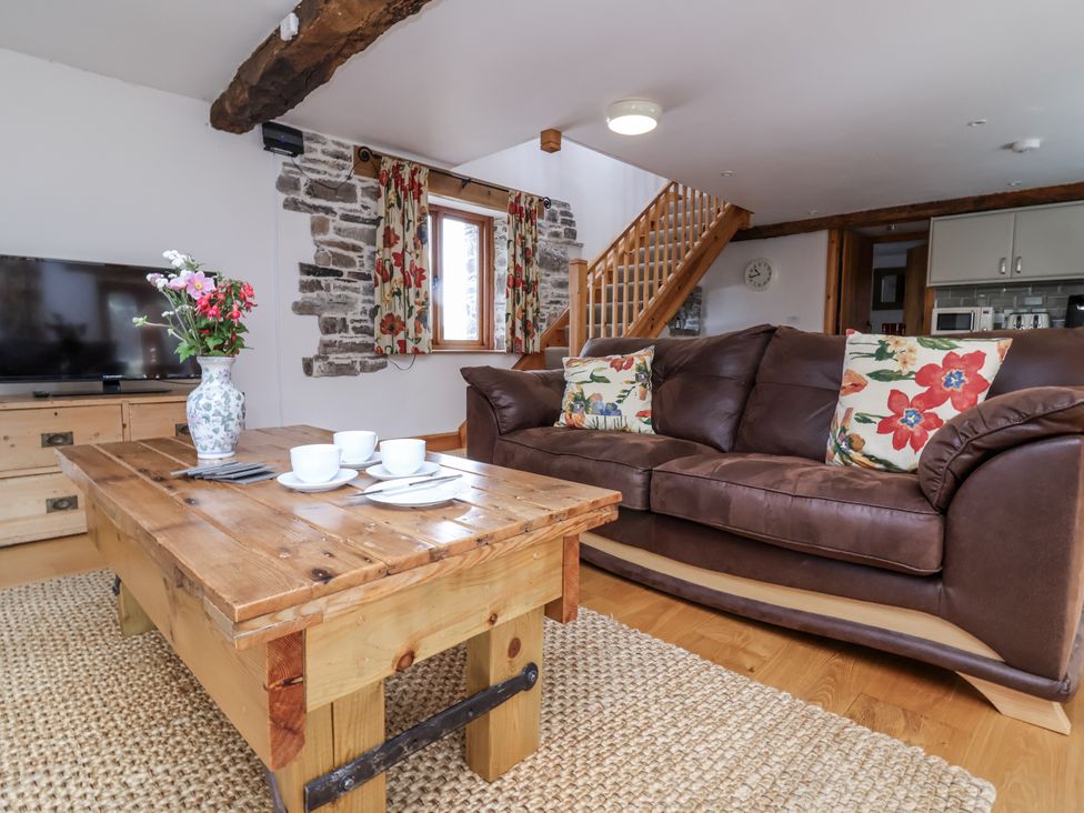 A living room with a sofa and coffee table at Lane End in North Molton