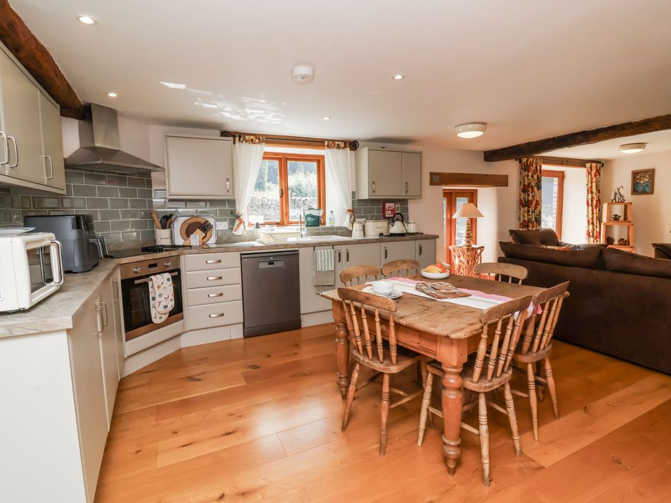A kitchen with a table and chairs at Lane End in North Molton