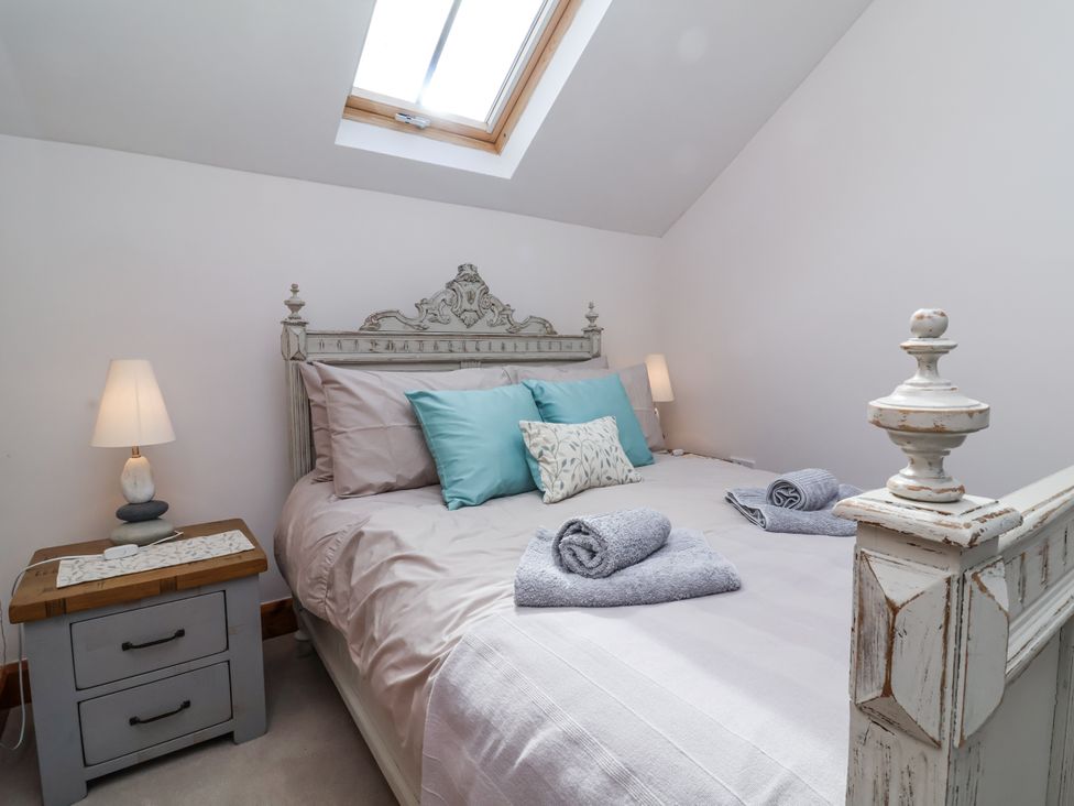 A bedroom with a bed and bedside table at Lane End in North Molton