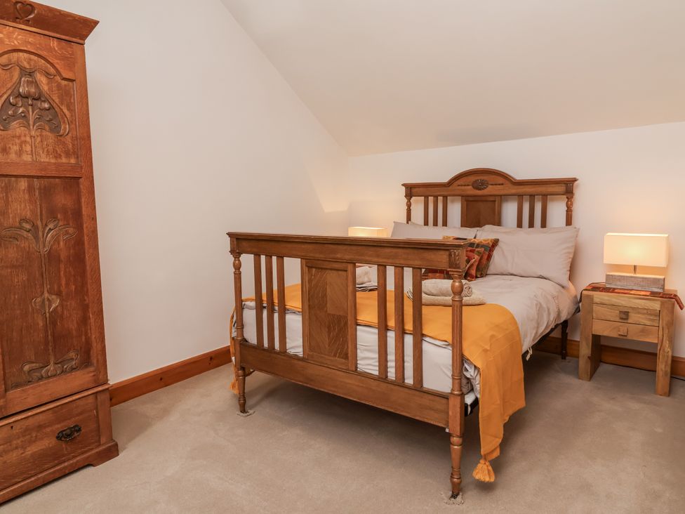 A bedroom with a bed and wardrobe at Lane End in North Molton