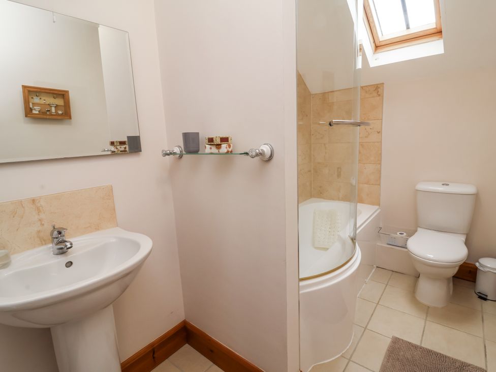 A bathroom with a sink, toilet, and bathtub at Lane End North Molton