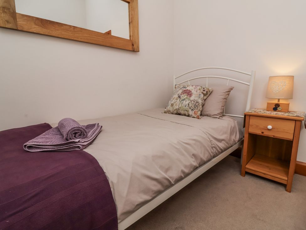A bed with a pillow and towel in a bedroom at Lane End North Molton