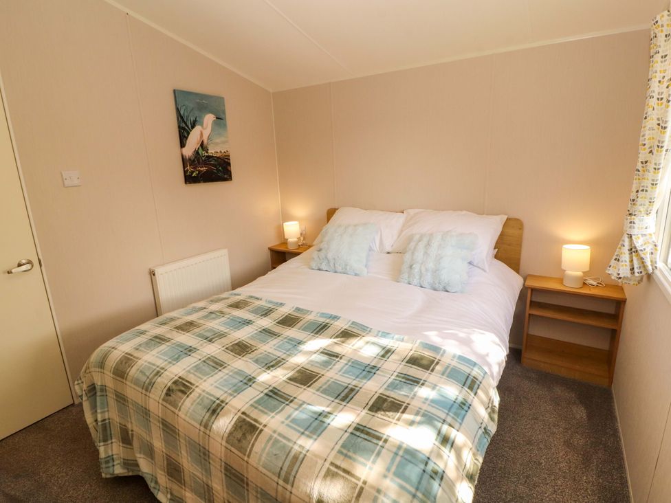 A bedroom with a bed and bedside tables at Barneys Retreat in Carnforth