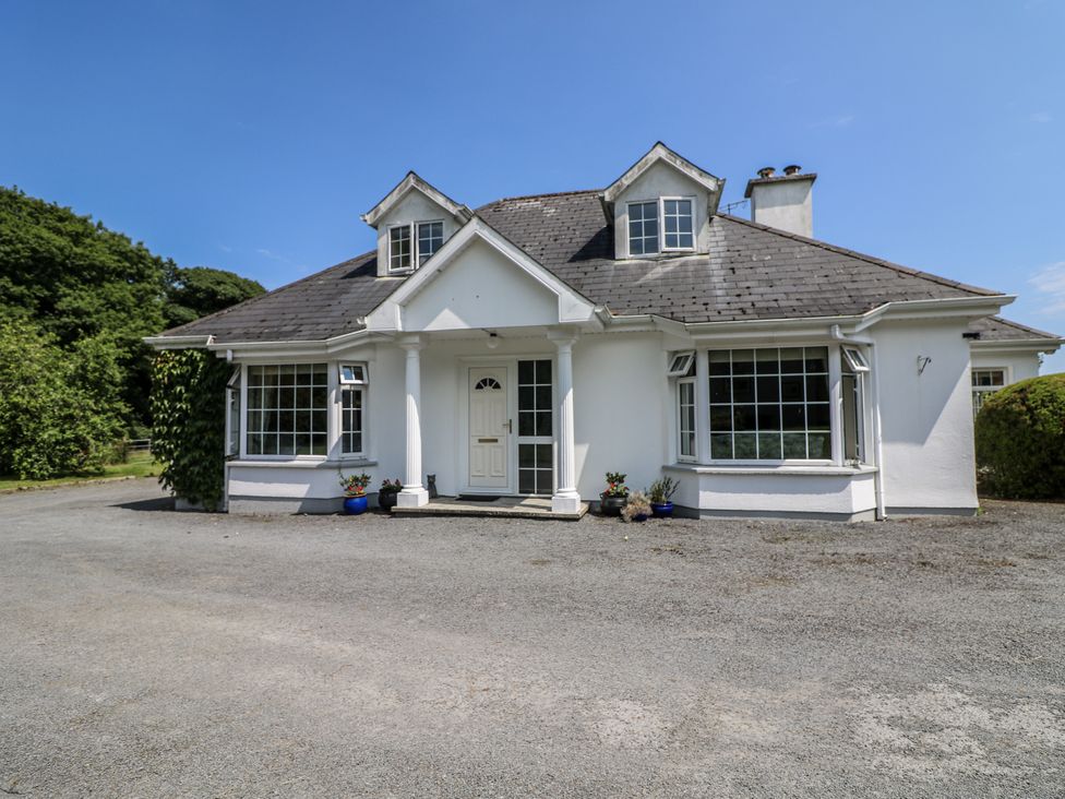 A house with a front door and windows at Knockroe Lodge in 