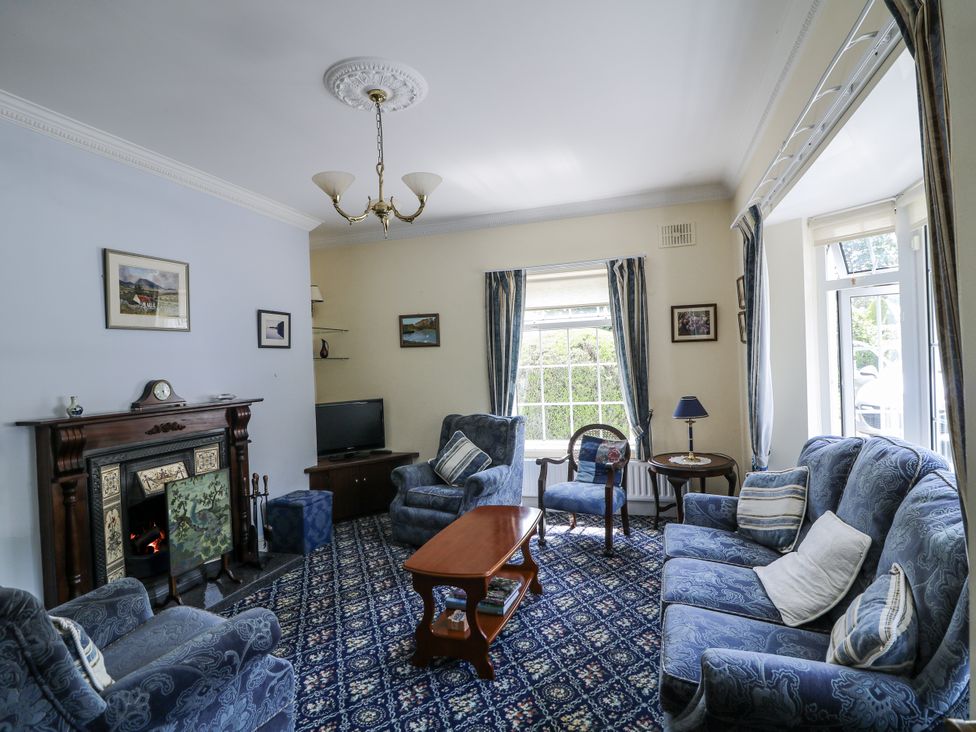 A living room with sofa and TV at Knockroe Lodge in 
