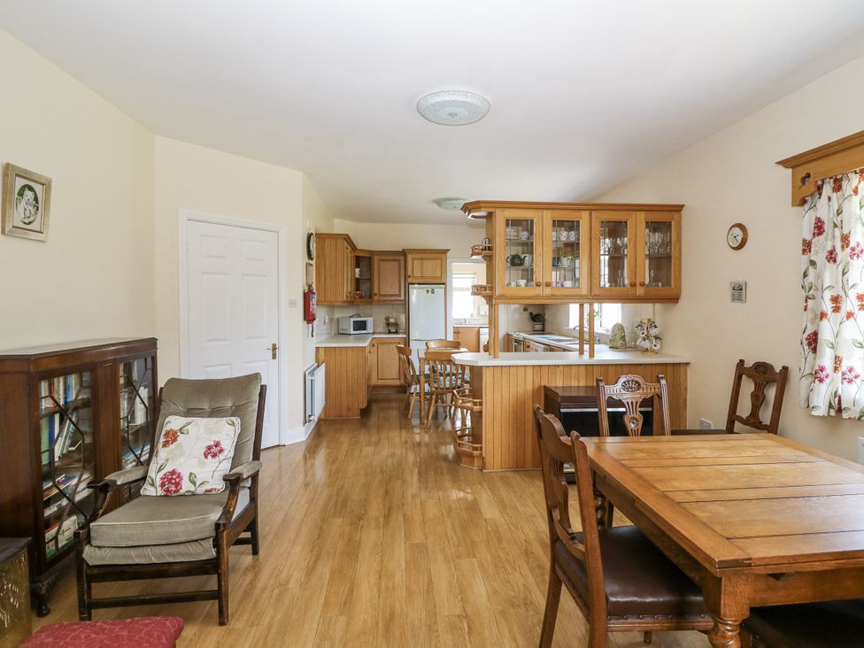 A dining room with a table and chairs at Knockroe Lodge