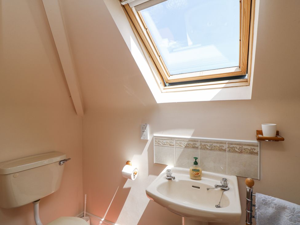 A bathroom with a toilet and sink at Knockroe Lodge 