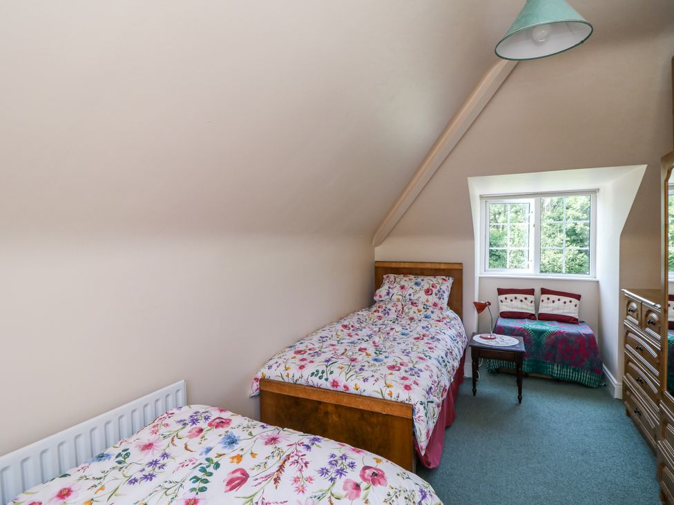 A bedroom with two beds and a window at Knockroe Lodge