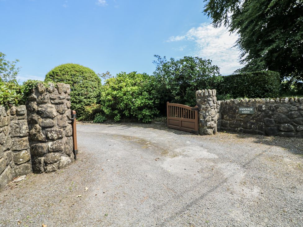 A gate and stone wall at Knockroe Lodge