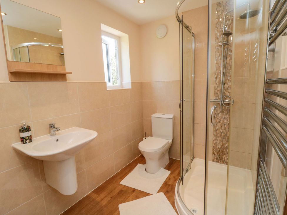 A bathroom with a shower and toilet at Scalby Grove Cottage, Scalby