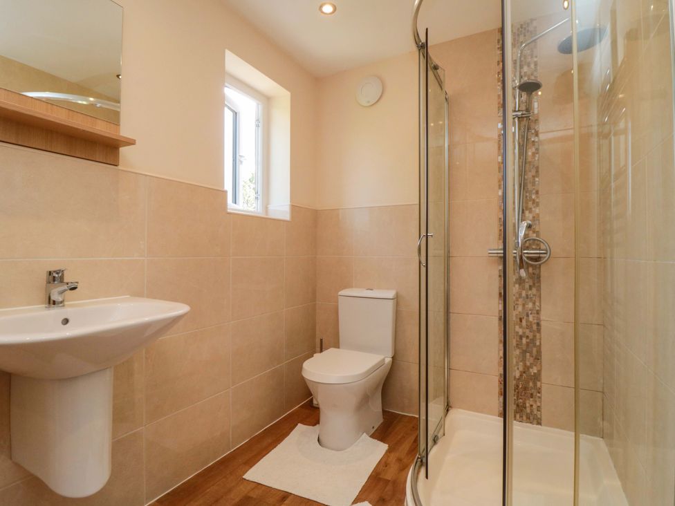 A bathroom with a sink, toilet, and shower at Scalby Grove Cottage, Scalby