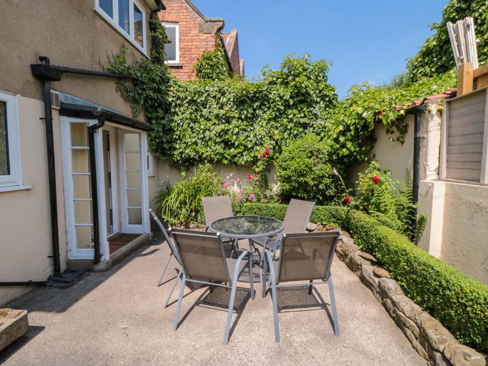 An outdoor area with a table and chairs at Scalby Grove Cottage in Scalby
