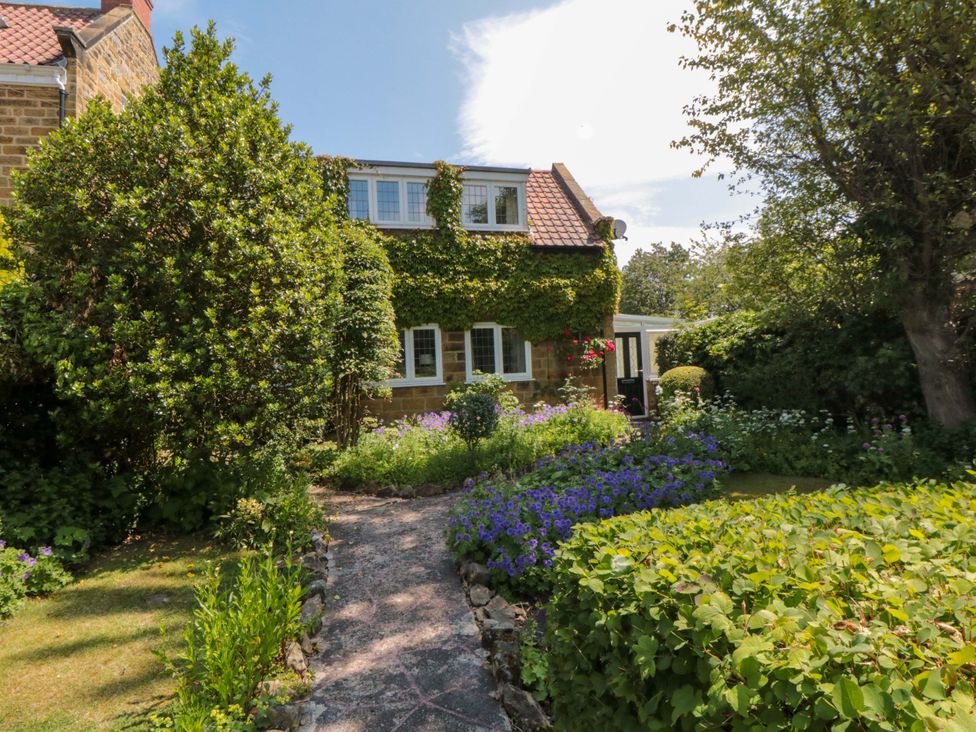 A house with a garden and pathway at Scalby Grove Cottage in Scalby