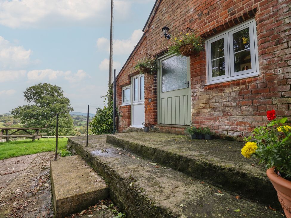 An entrance with stairs leading to a door at Upper Pandy Farm in Welshpool