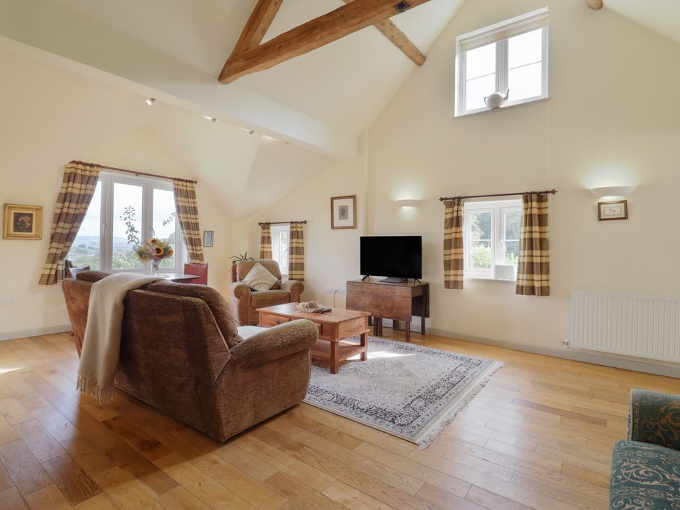 A living room with furniture and a television at Upper Pandy Farm in Welshpool