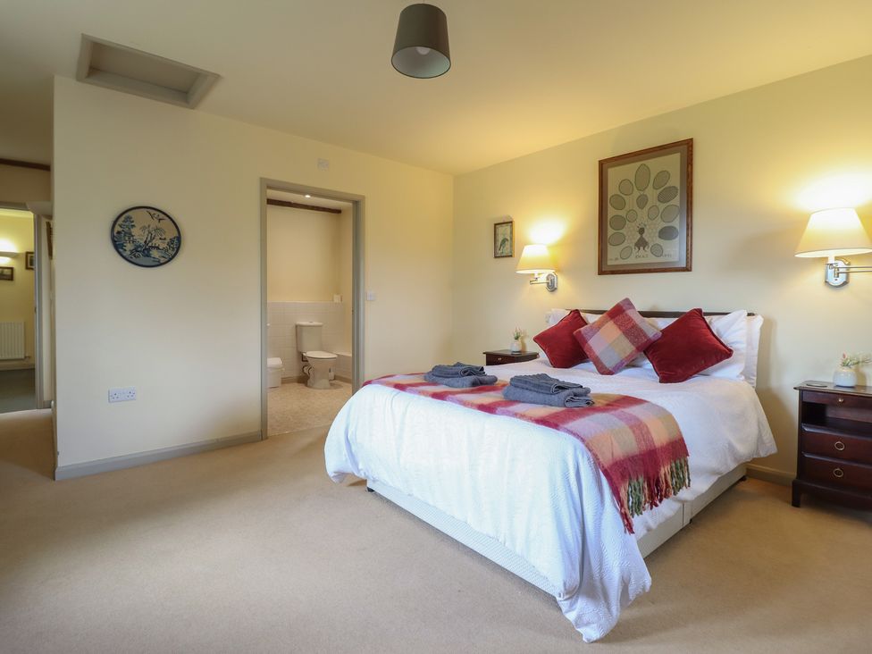 A bedroom with a bed and nightstand at Upper Pandy Farm in Welshpool