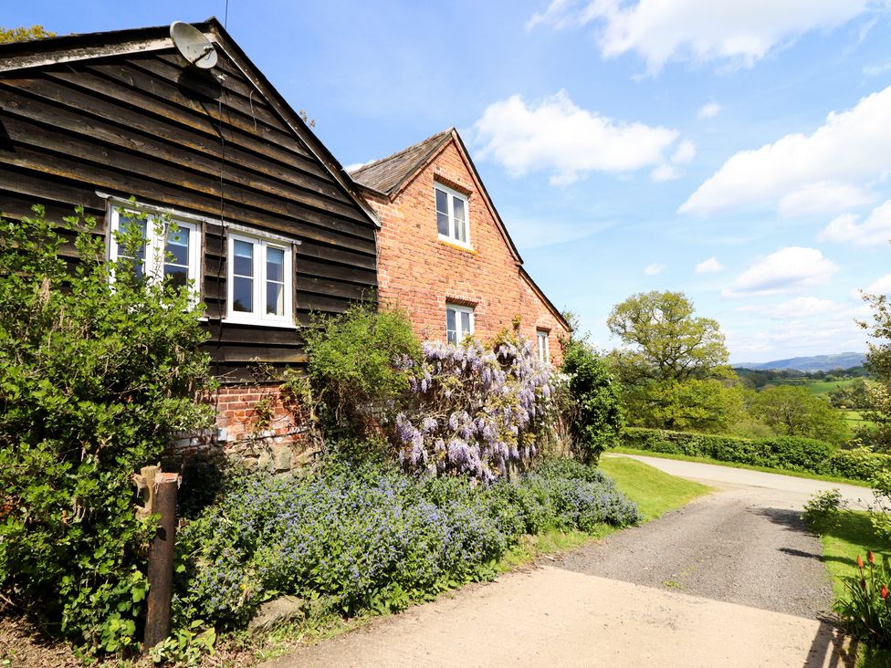 A building with plants and a pathway at Upper Pandy Farm Berriew near Welshpool