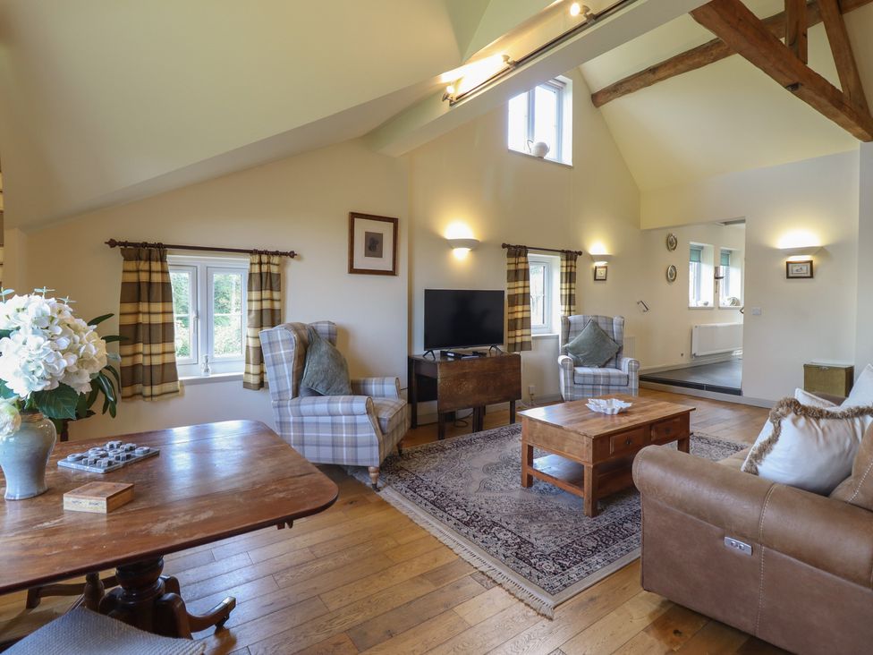 A living room with a sofa and a coffee table at Upper Pandy Farm Berriew near Welshpool