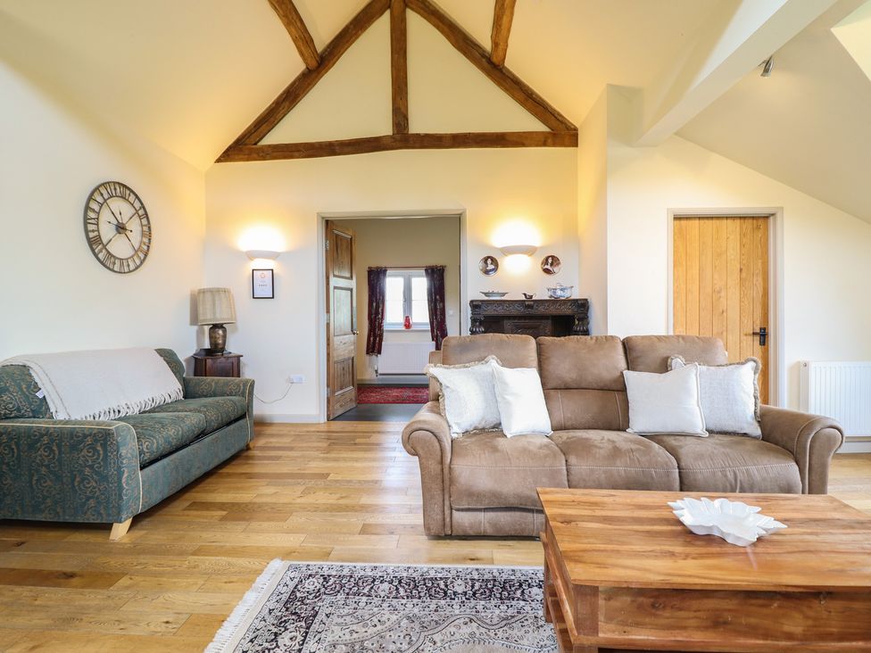 A living room with a sofa and coffee table at Upper Pandy Farm in Berriew near Welshpool