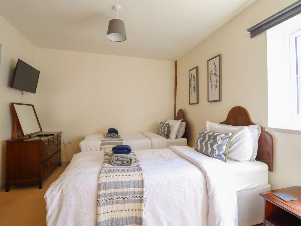 A bedroom with two beds and a dresser at Upper Pandy Farm Berriew near Welshpool