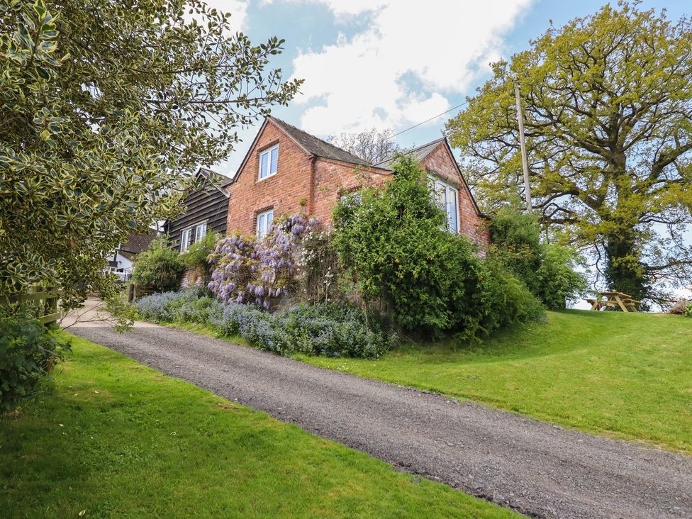 A house with surrounding garden and pathway at Upper Pandy Farm in Berriew near Welshpool