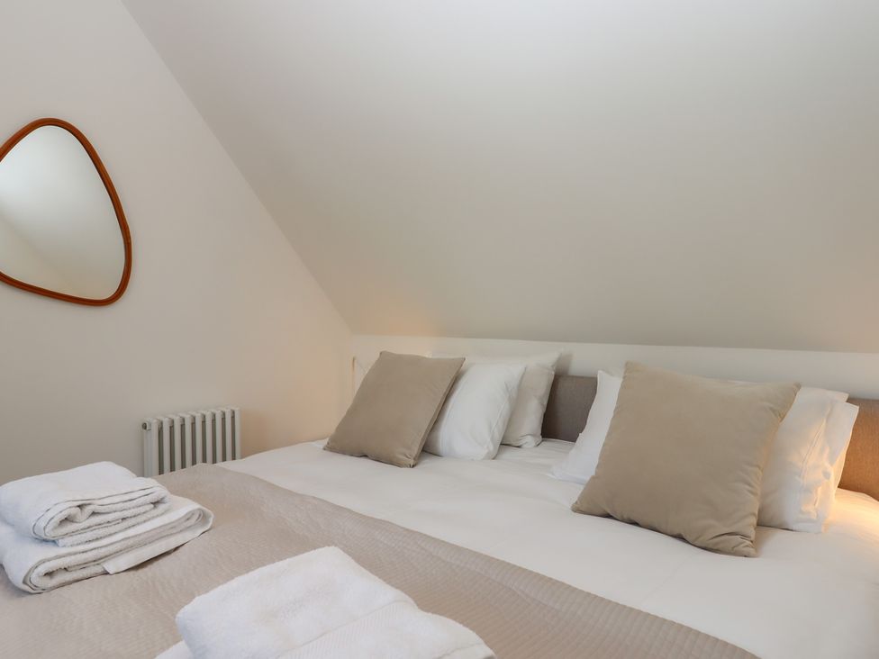 A bedroom with a bed and pillows at Jams in Lympstone