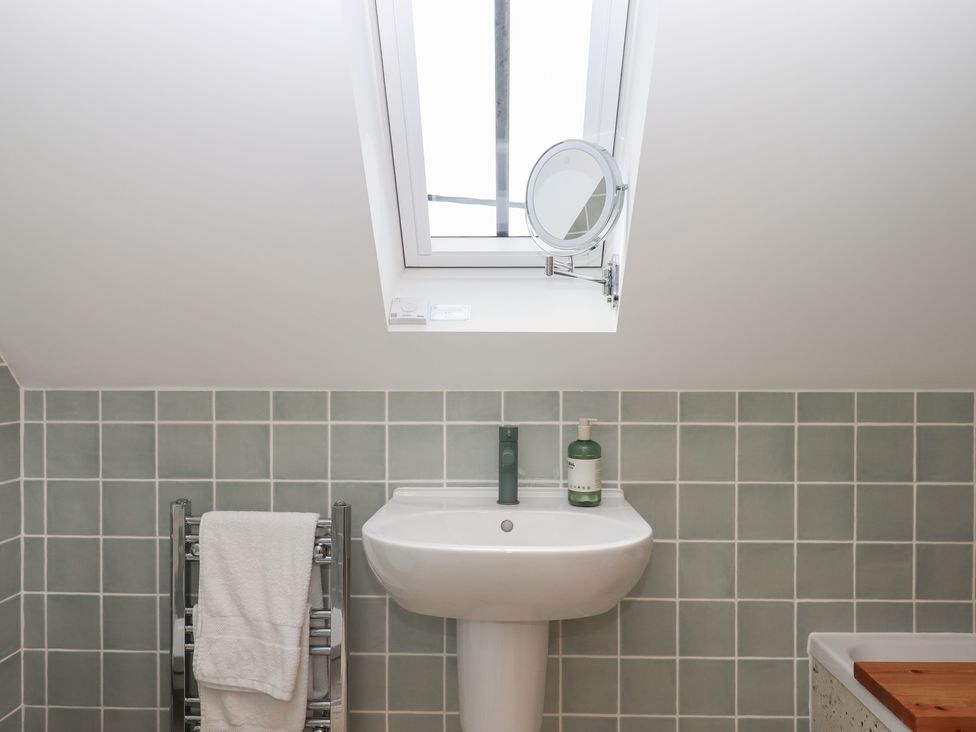 A bathroom with a sink and mirror at Jams in Lympstone