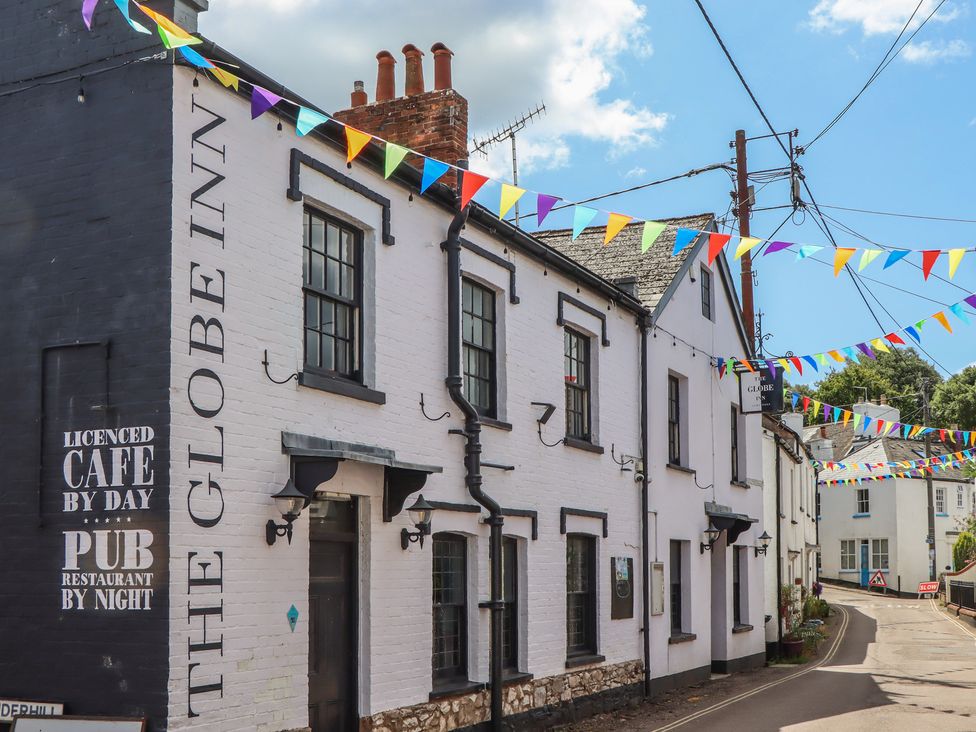 An exterior view of The Globe Inn with colorful bunting in Lympstone