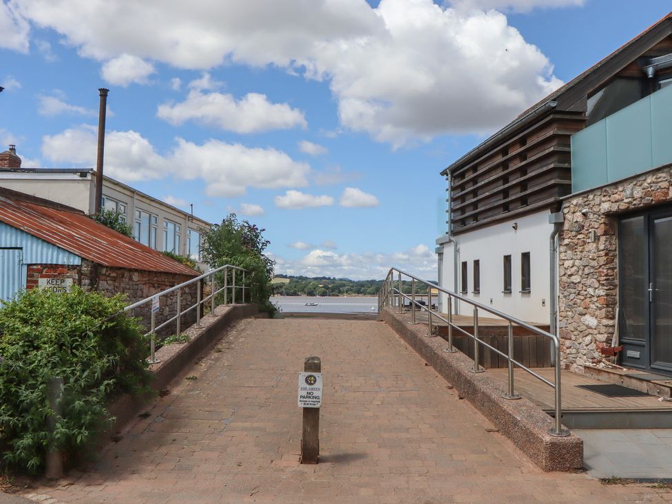 An outdoor area with a paved pathway and buildings at Jams in Lympstone
