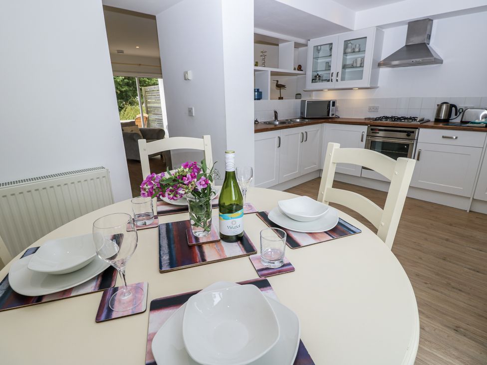 A dining area with a table set for meals at Vermont 4 in Yarmouth
