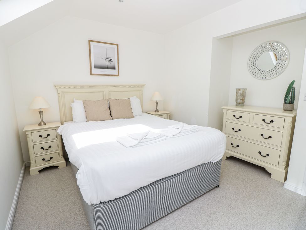 A bedroom with a bed and dresser at Vermont 4 in Yarmouth